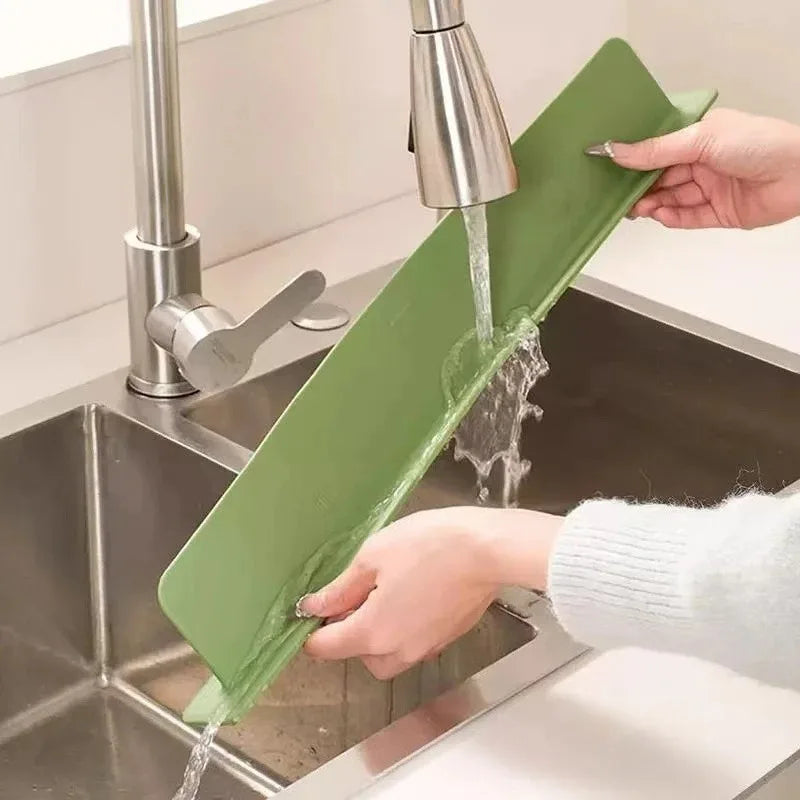 Sink splash guard preventing water from splashing onto kitchen counter